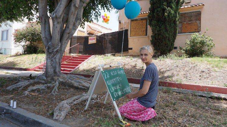 Anne Hars in front bungalows slated for demolition